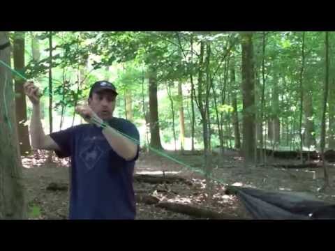 Man using whoopie hook complete suspension to hang his hammock