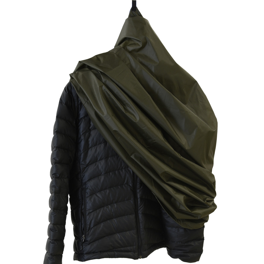 green garment folded on black jacket