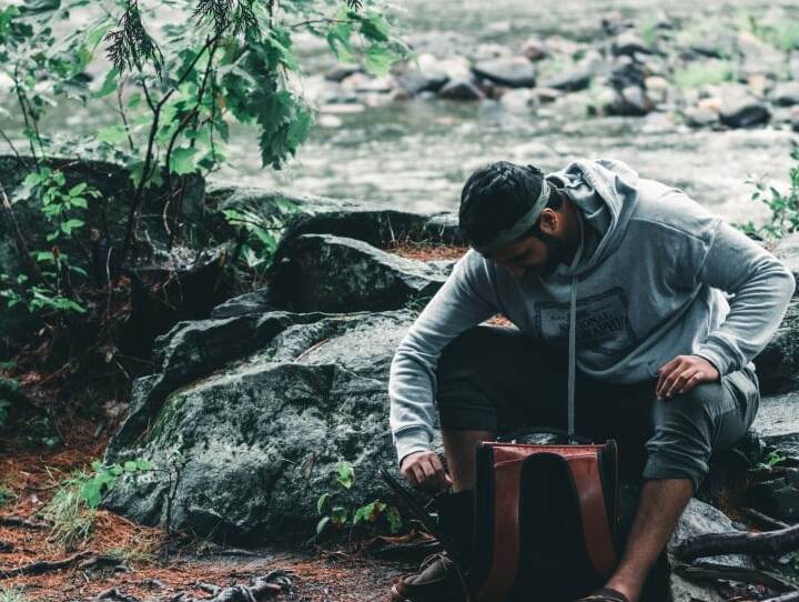 cat and guy hiking in forest