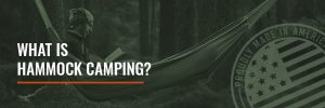 a man laying in a camping hammock